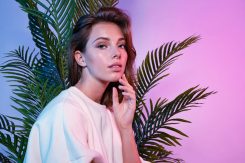 Beautiful,Female,Touching,Face,With,Tenderness.,Lady,Sitting,Near,Green