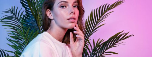 Beautiful,Female,Touching,Face,With,Tenderness.,Lady,Sitting,Near,Green
