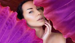 Young,Woman's,Face,Surrounded,By,Colored,Tropical,Leaves.,Woman,Face